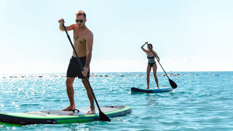 Couple paddle surfing